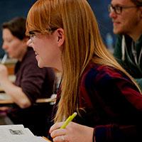 A student smiles while participating in a class.